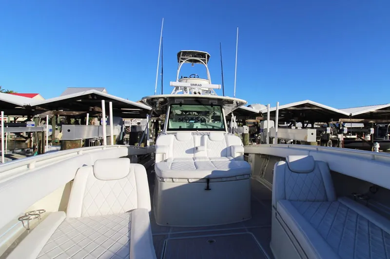 Slide: The Image of 2017 HCB Suenos boat with luxurious seating and sleek design at a marina. - 17