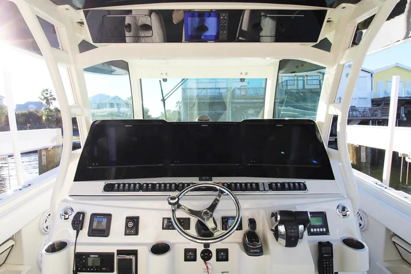 Slide: The Image of 2017 HCB Suenos boat helm with advanced navigation controls and steering wheel. - 23