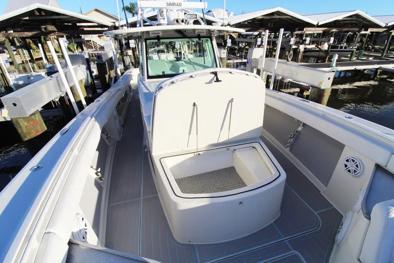Slide: The Image of 2017 HCB Suenos boat docked, showcasing spacious deck and storage area. - 27