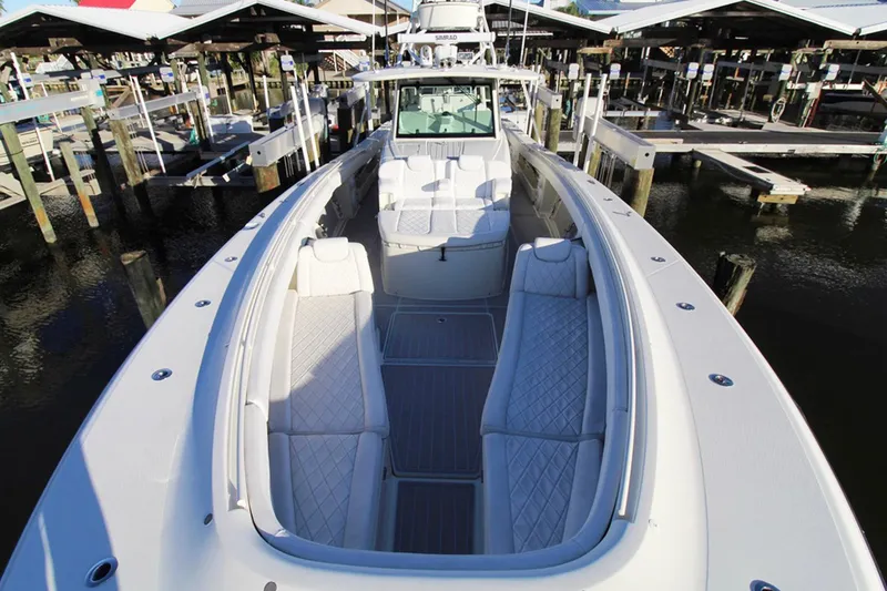 Slide: The Image of 2017 HCB Suenos boat with spacious seating at a marina. - 29