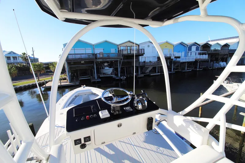 Slide: The Image of HCB Suenos 2017 boat helm with colorful waterfront houses in the background. - 31
