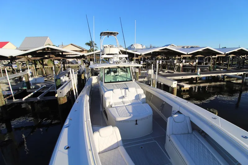 Slide: The Image of 2017 HCB Suenos boat docked at marina under clear blue sky. - 34