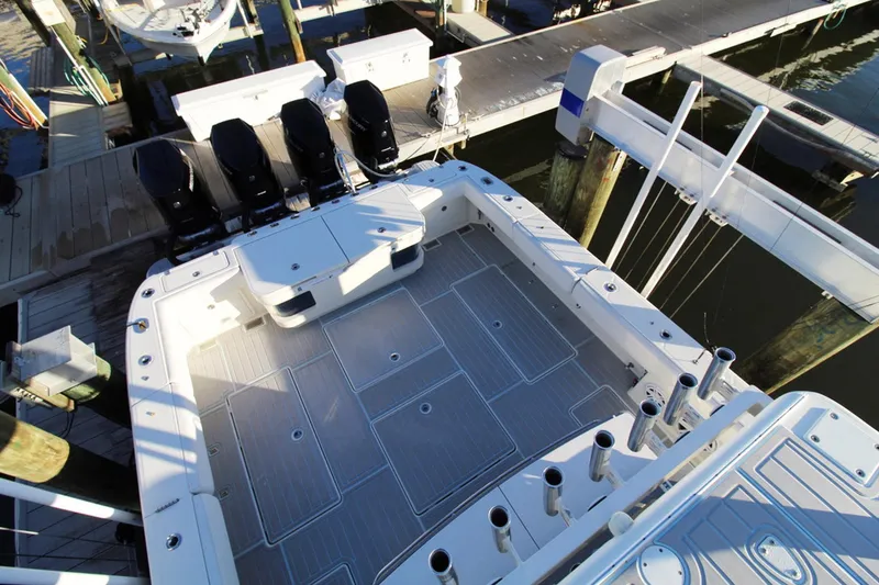 Slide: The Image of 2017 HCB Suenos boat with spacious deck and multiple outboard engines at dock. - 37