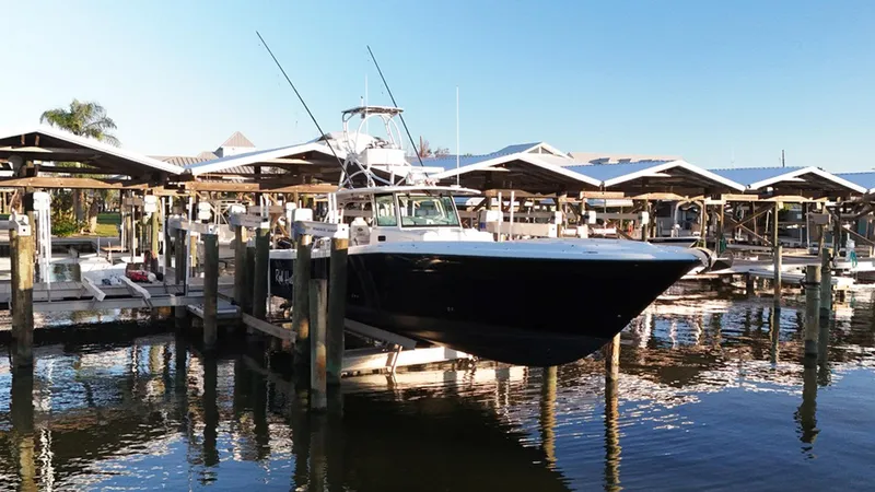 Slide: The Image of 2017 HCB Suenos boat docked at marina under clear blue sky. - 39