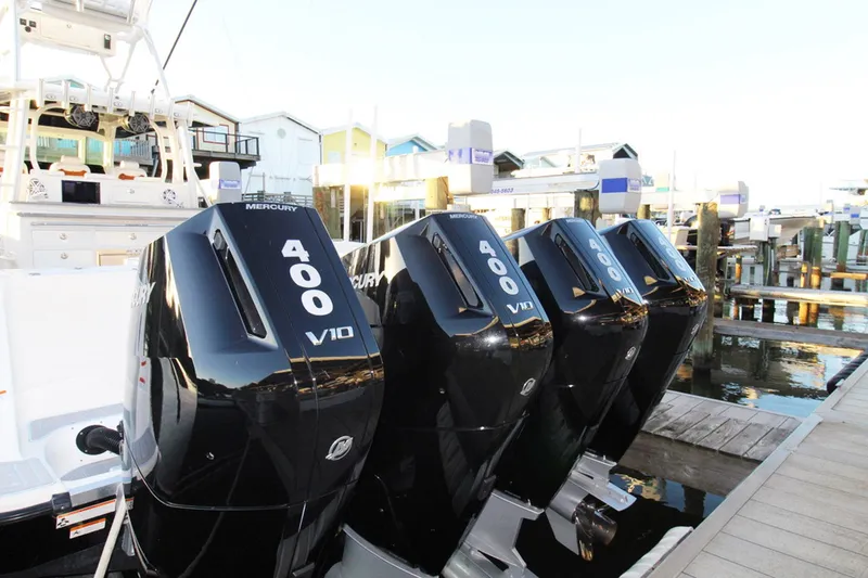 Slide: The Image of 2017 HCB Suenos boat with four Mercury 400 V10 engines docked at marina. - 4