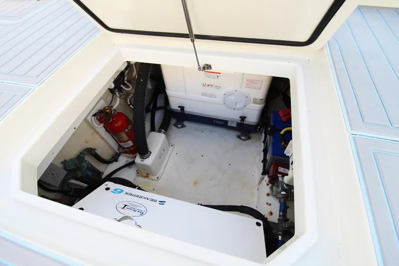 Slide: The Image of Open hatch of 2017 HCB Suenos boat showing interior equipment and fire extinguisher. - 40