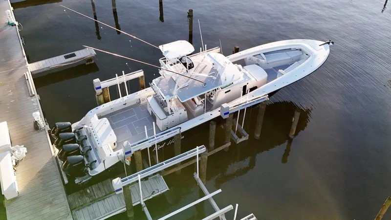 Slide: The Image of 2017 HCB Suenos boat docked with multiple outboard engines, aerial view. - 42