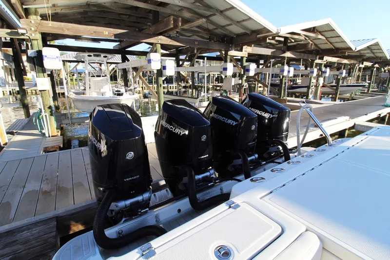 Slide: The Image of 2017 HCB Suenos boat with triple Mercury outboard engines docked at a marina. - 5