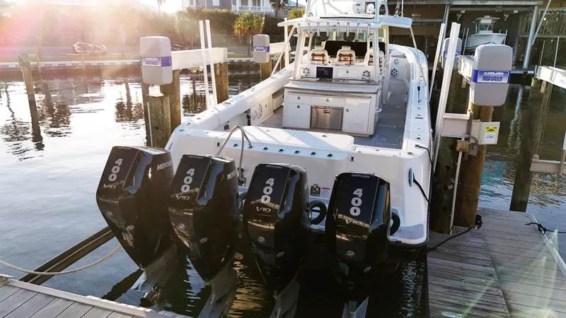 Slide: The Image of 2017 HCB Suenos boat with four powerful outboard engines docked at marina. - 8