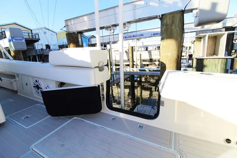 Slide: The Image of 2017 HCB Suenos boat docked, showcasing sleek deck design and modern features. - 9