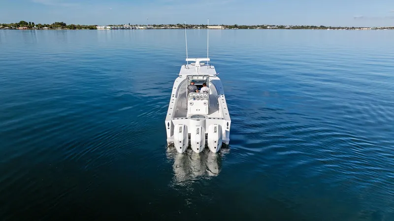Slide: The Image of 2018 Onslow Bay 33 Tournament boat on calm water, rear view. - 12