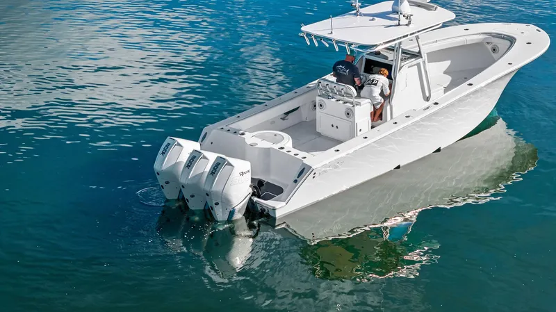 Slide: The Image of 2018 Onslow Bay 33 Tournament boat on clear water, featuring dual outboard engines. - 15