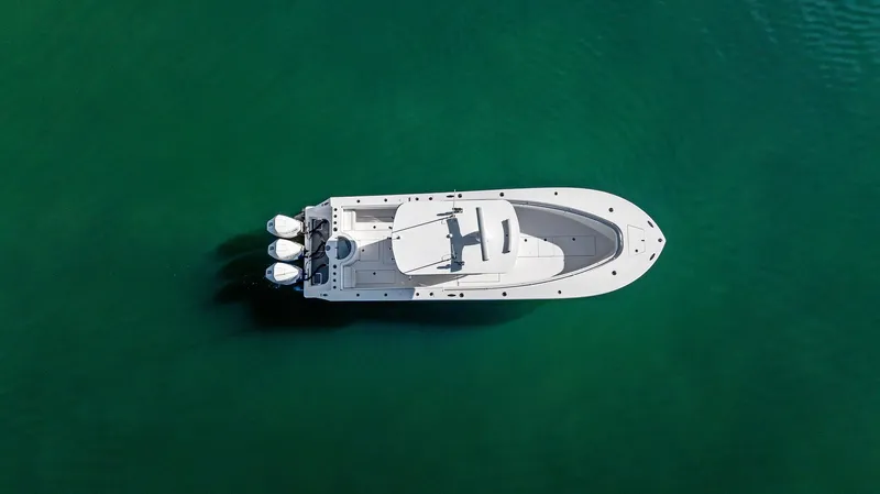 Slide: The Image of Aerial view of 2018 Onslow Bay 33 Tournament boat on clear green water. - 19