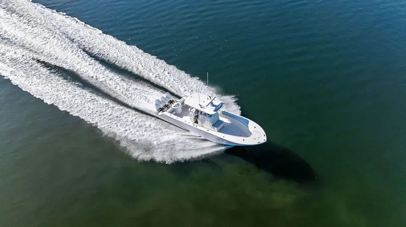 Slide: The Image of Aerial view of 2018 Onslow Bay 33 Tournament boat speeding on water. - 21