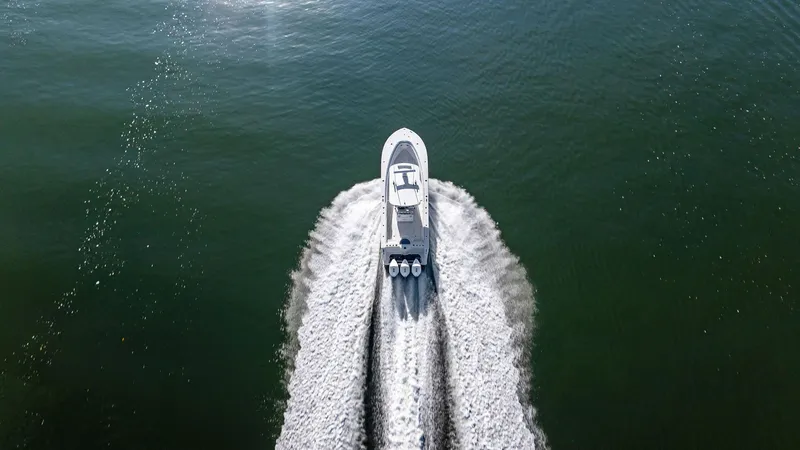 Slide: The Image of Aerial view of 2018 Onslow Bay 33 Tournament boat speeding on water. - 22