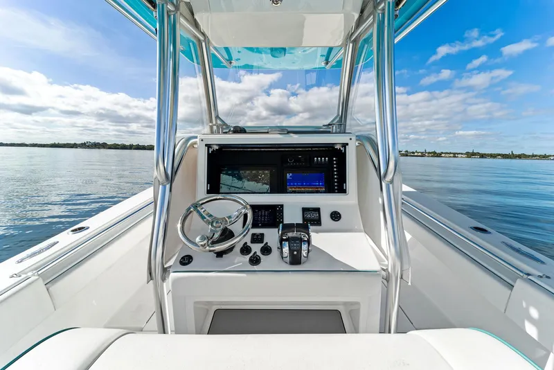 Slide: The Image of 2018 Onslow Bay 33 Tournament boat cockpit with steering wheel and navigation system. - 37
