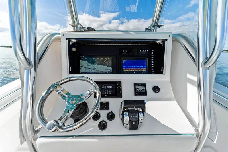 Slide: The Image of 2018 Onslow Bay 33 Tournament boat dashboard with steering wheel and navigation controls. - 39