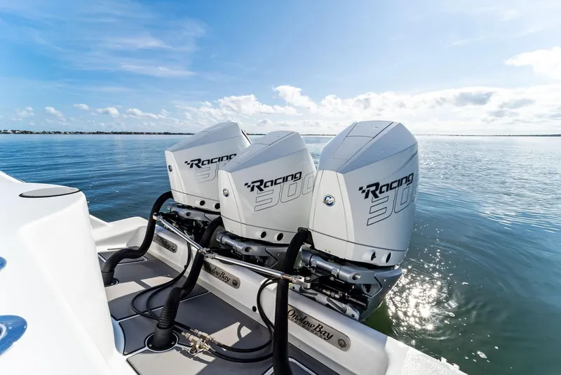 Slide: The Image of 2018 Onslow Bay 33 Tournament boat with triple Racing 300 engines on calm water. - 45