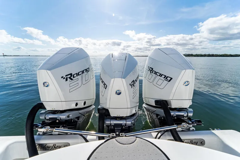 Slide: The Image of 2018 Onslow Bay 33 Tournament boat with triple Racing 300 engines on calm water. - 46
