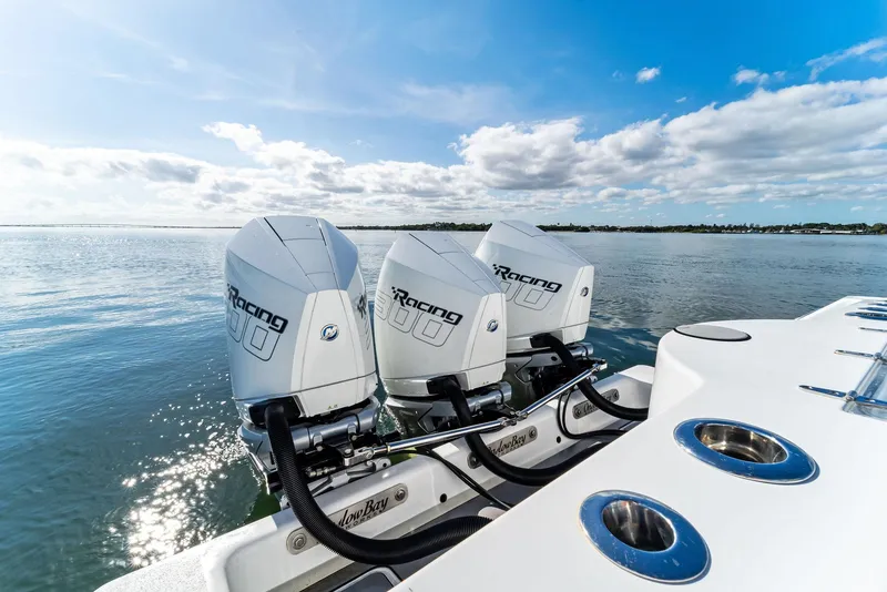 Slide: The Image of 2018 Onslow Bay 33 Tournament boat with triple outboard engines on calm water. - 47