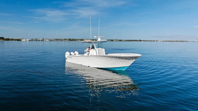 Slide: The Image of 2018 Onslow Bay 33 Tournament boat on calm water under clear blue sky. - 9