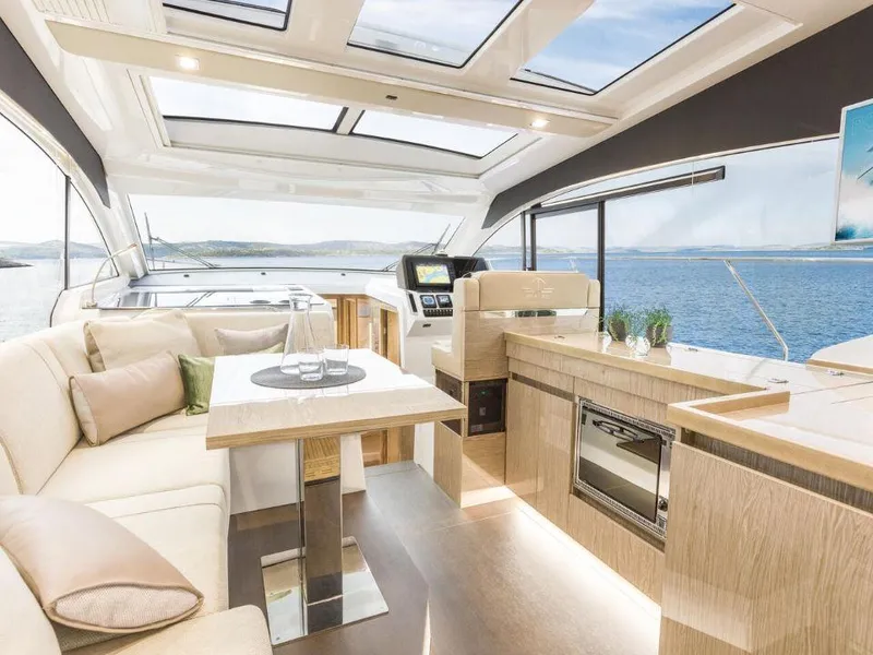 Slide: The Image of Luxurious interior of 2025 Sealine C390 yacht with panoramic windows and modern furnishings. - 11