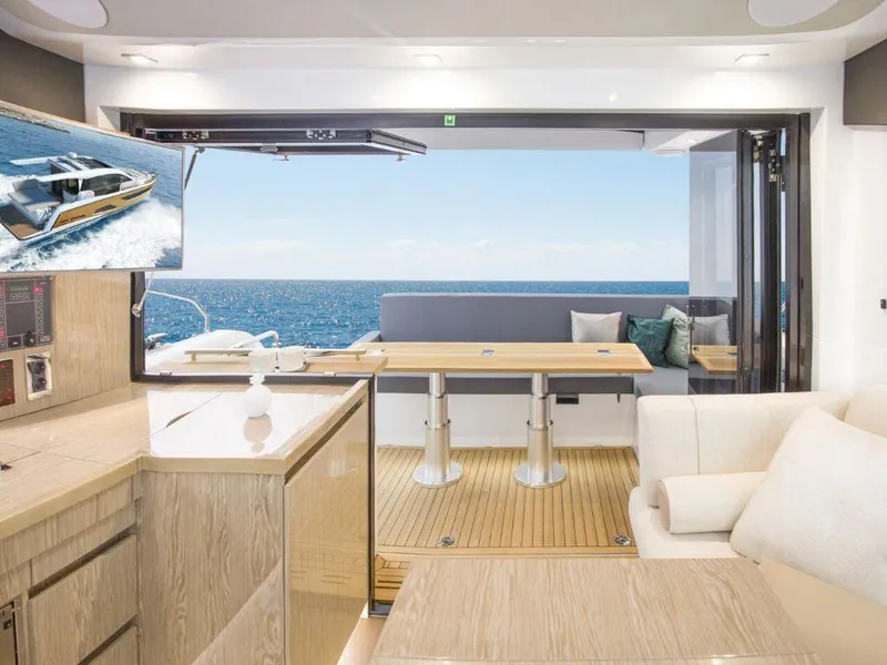 Slide: The Image of 2025 Sealine C390 yacht interior with ocean view, featuring modern design and comfortable seating. - 13