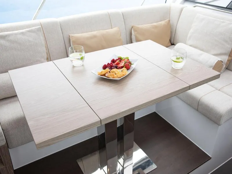 Slide: The Image of Luxurious interior of 2025 Sealine C390 yacht with elegant dining setup. - 14