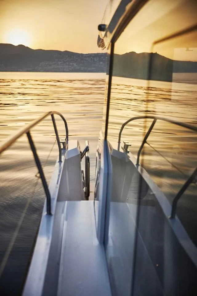 Slide: The Image of 2025 Sealine C390 yacht reflecting sunset on calm waters. - 5