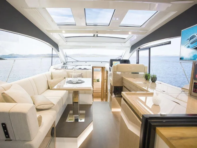 Slide: The Image of Luxurious interior of 2025 Sealine C390 yacht with panoramic windows and modern furnishings. - 6
