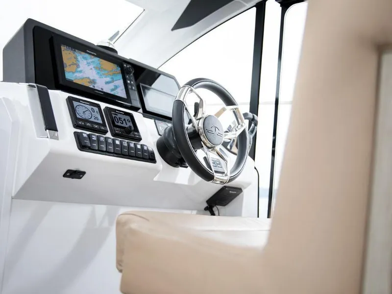 Slide: The Image of Helm of 2025 Sealine C390 yacht with modern navigation equipment and steering wheel. - 9