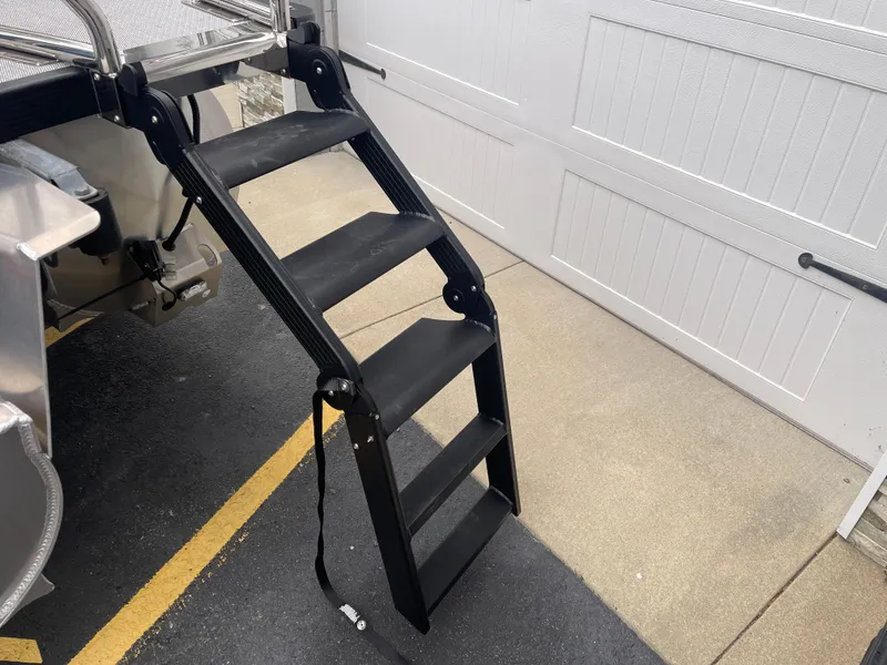 Slide: The Image of 2025 Avalon 2585 Excalibur LTD boat ladder, black, sturdy design, near garage door. - 11