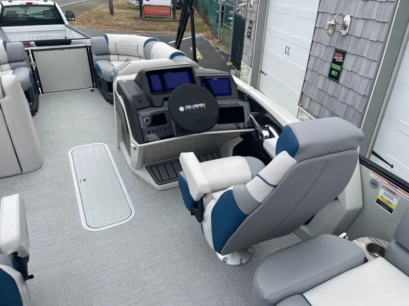Slide: The Image of 2025 Avalon 2585 Excalibur LTD boat interior with modern dashboard and seating. - 27