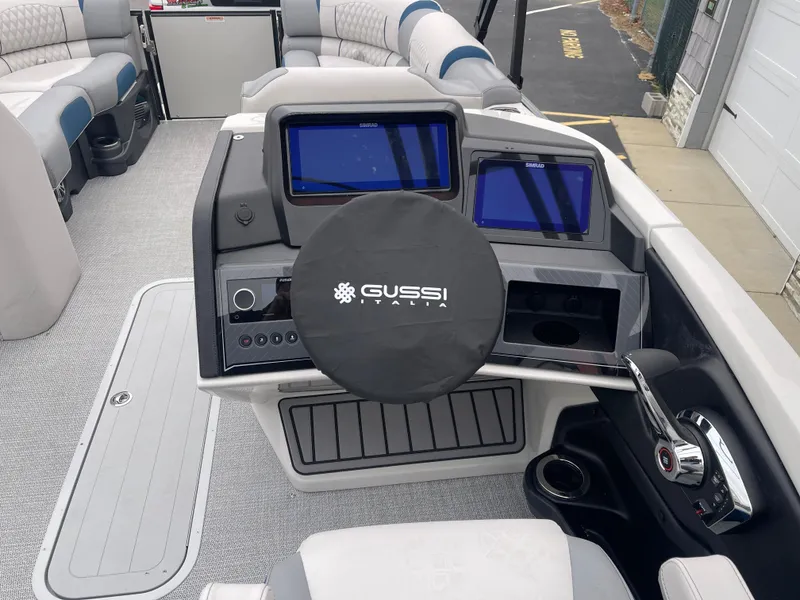 Slide: The Image of 2025 Avalon 2585 Excalibur LTD boat dashboard with Gussi Italia steering wheel and dual displays. - 30