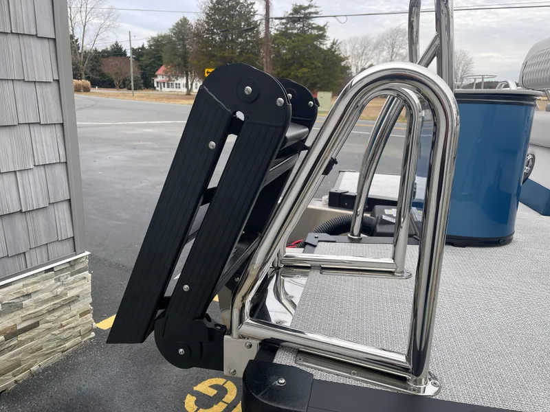 Slide: The Image of Stainless steel ladder on 2025 Avalon 2585 Excalibur LTD boat, parked outdoors. - 9