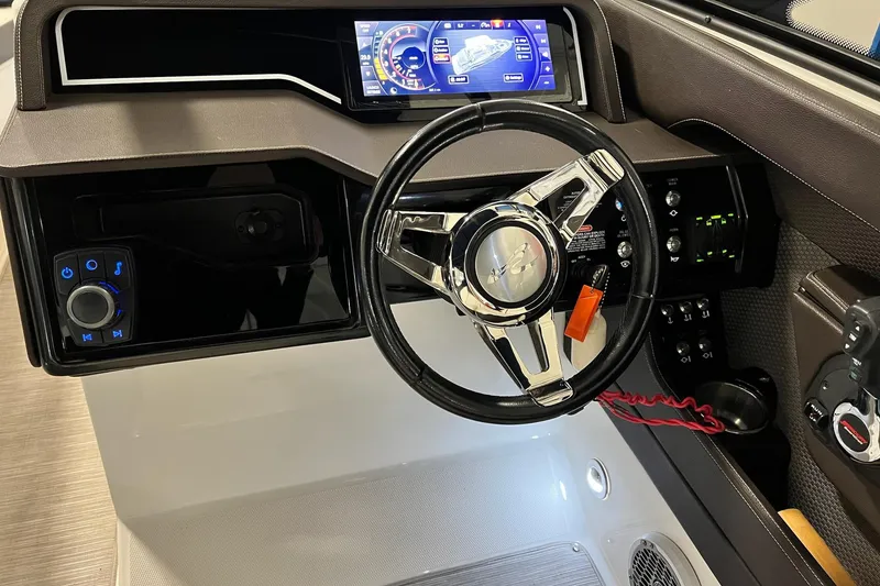 Slide: The Image of 2017 Sea Ray 280 SLX dashboard with modern steering wheel and digital display. - 15