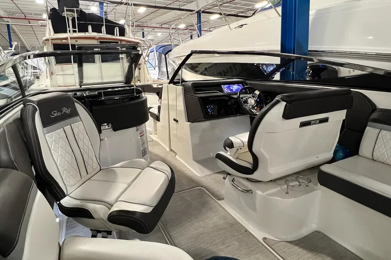 Slide: The Image of 2017 Sea Ray 280 SLX boat interior with luxurious seating and modern dashboard. - 16
