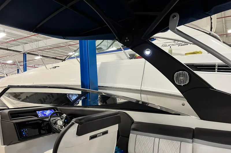 Slide: The Image of 2017 Sea Ray 280 SLX boat interior with modern dashboard and seating in a showroom. - 21