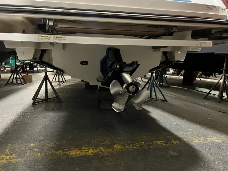 Slide: The Image of 2017 Sea Ray 280 SLX boat on stands, showing propeller and hull. - 28