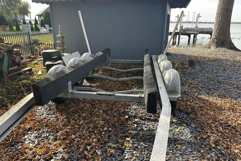 Slide: The Image of Boat trailer on gravel near water, designed for 2017 Sea Ray 280 SLX. - 32