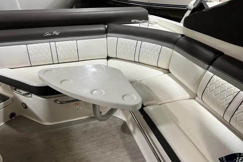 Slide: The Image of Interior seating of 2017 Sea Ray 280 SLX with white and black upholstery. - 8
