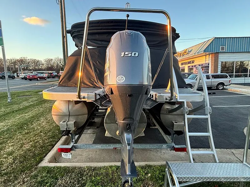 Slide: The Image of 2023 Bennington 23 L Fastback pontoon boat with 150 HP engine on trailer. - 3