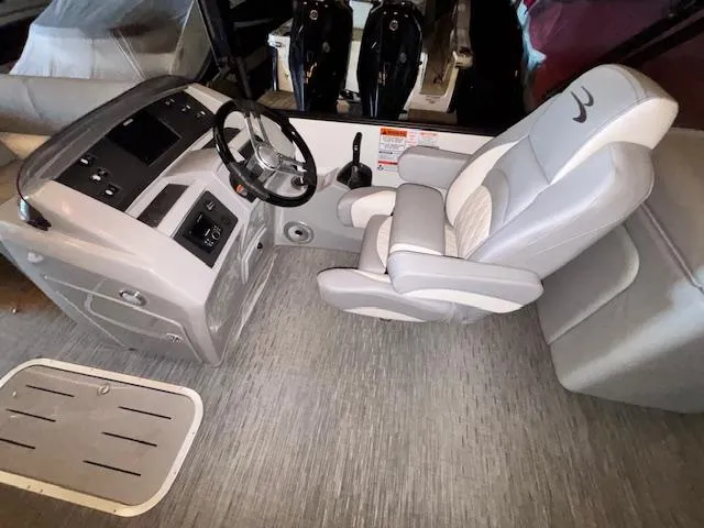 Slide: The Image of 2023 Bennington 23 L Fastback boat interior with steering console and captain's chair. - 4