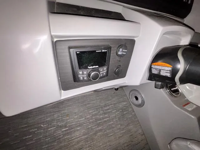 Slide: The Image of 2023 Bennington 23 L Fastback dashboard with control panel and steering wheel. - 6