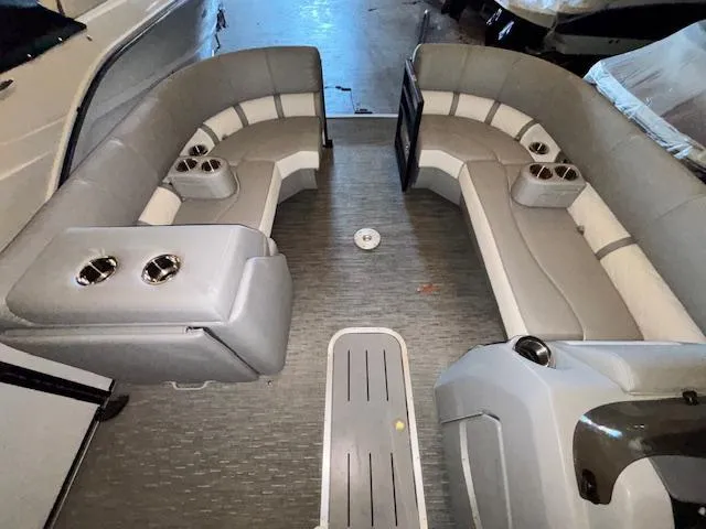 Slide: The Image of 2023 Bennington 23 L Fastback boat interior with gray seating and cup holders. - 7
