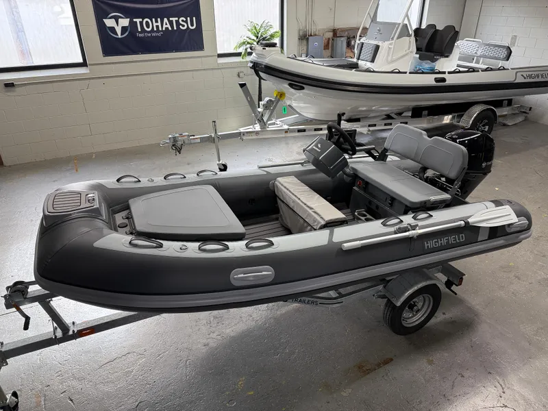Slide: The Image of 2025 Highfield Classic 380 FCT inflatable boat on trailer in showroom. - 0
