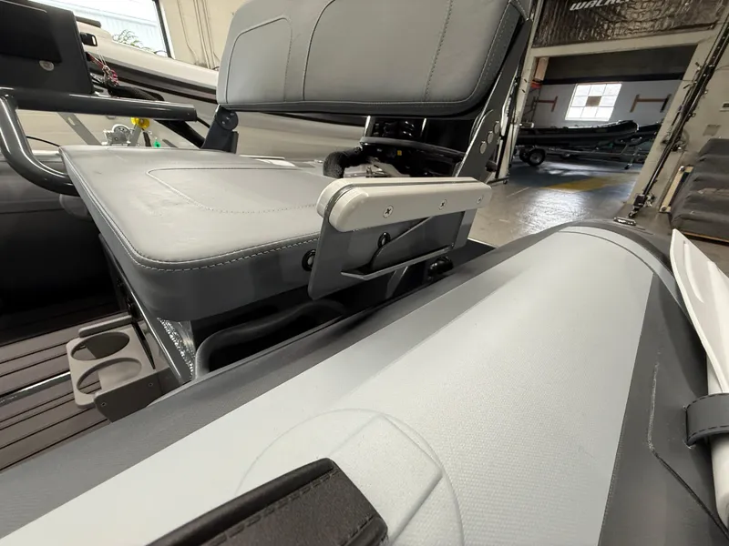 Slide: The Image of 2025 Highfield Classic 380 FCT boat interior with gray seating and cup holders. - 11