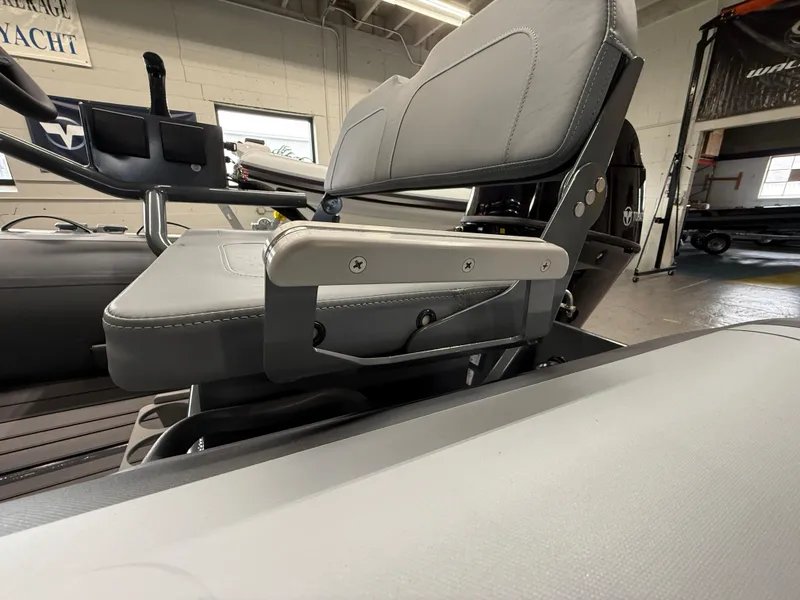 Slide: The Image of Highfield Classic 380 FCT 2025 boat interior with gray seating and armrest detail. - 12