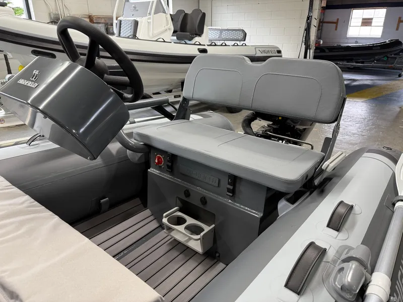 Slide: The Image of 2025 Highfield Classic 380 FCT boat interior with steering console and seating. - 13