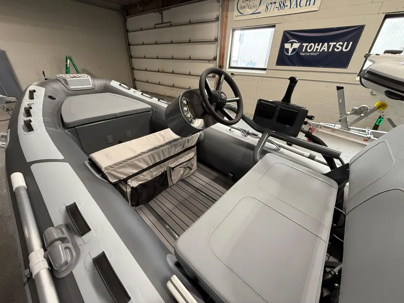 Slide: The Image of 2025 Highfield Classic 380 FCT boat interior with steering wheel and seating. - 2